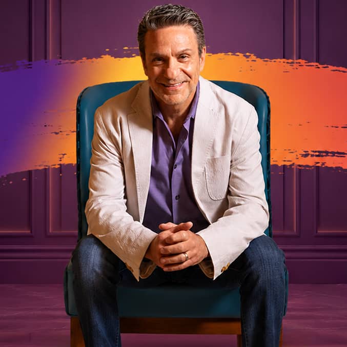 Jason Milen sitting and looking forward with special background